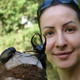 Iva Njunjić of Taxon Expeditions poses with a Southeast Asian rhinoceros beetle